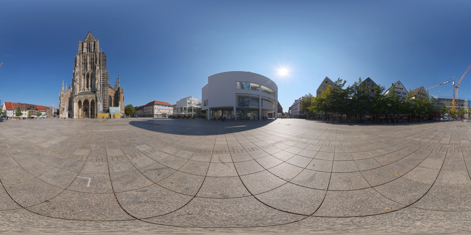 The whole 360° photo of the square in Ulm as it is stored: a stretched rectangle, the Minster small at the center